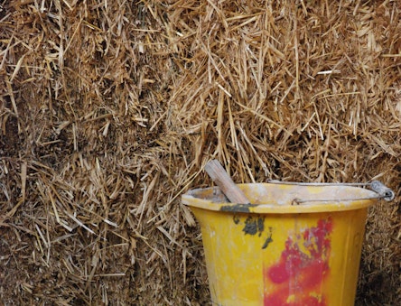 Strawbale wall with a bucket in front