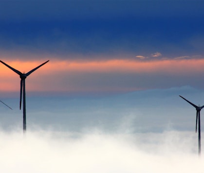 Wind turbines at dawn - one of many practical solutions to climate change