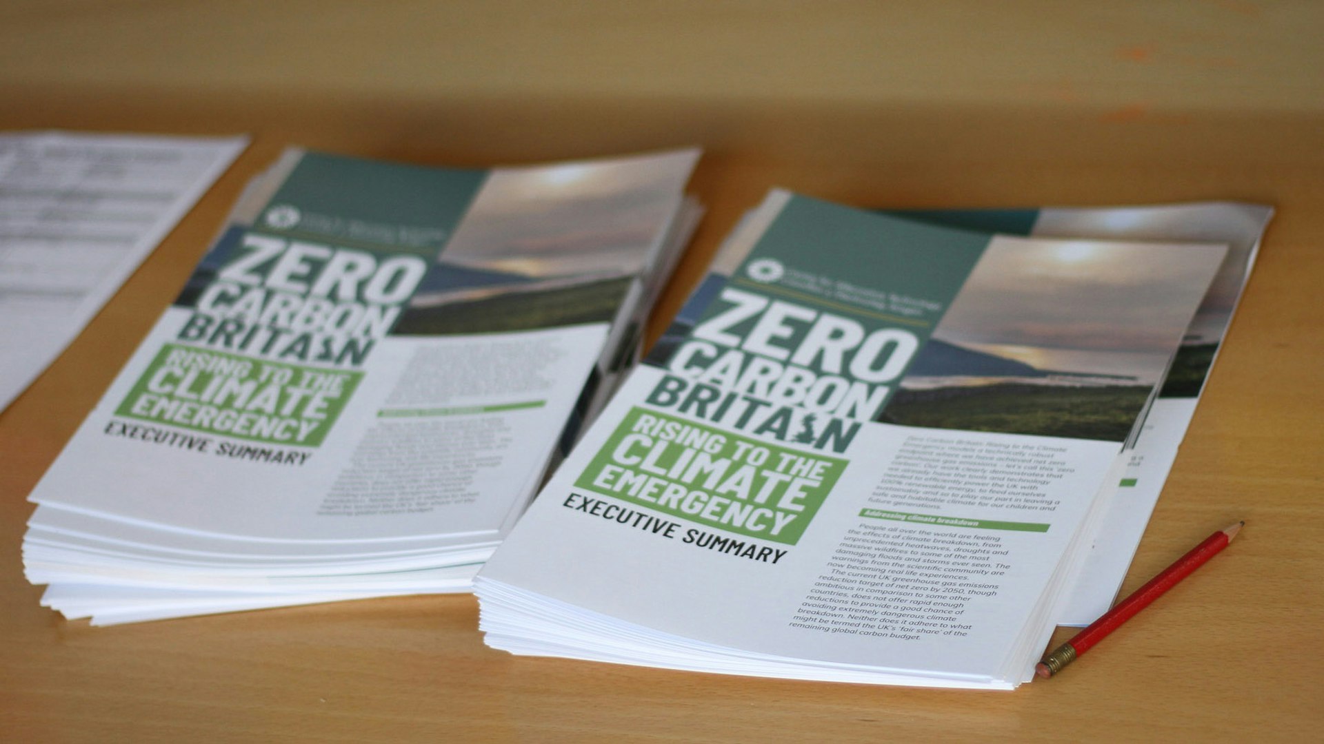 Zero Carbon Britain: Rising to the Climate Emergency Summary reports piled on a table