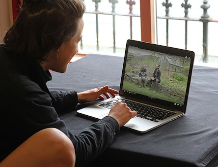 Women watches a video about CAT on a laptop