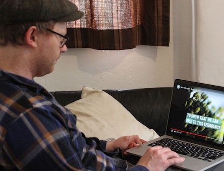 Man looking at the CAT website on a laptop