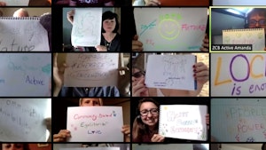 Screenshot of people holding up paper with a message on Zoom attending a Zero Carbon Britain Course