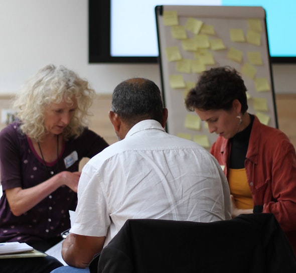 Four people in a conference group session