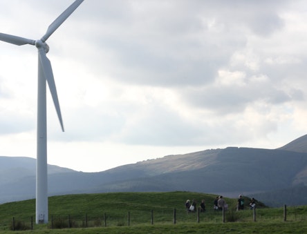 CAT students by a wind turbine