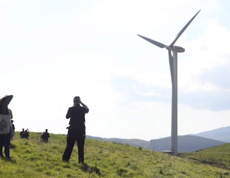 CAT students walking towards a wind turbine