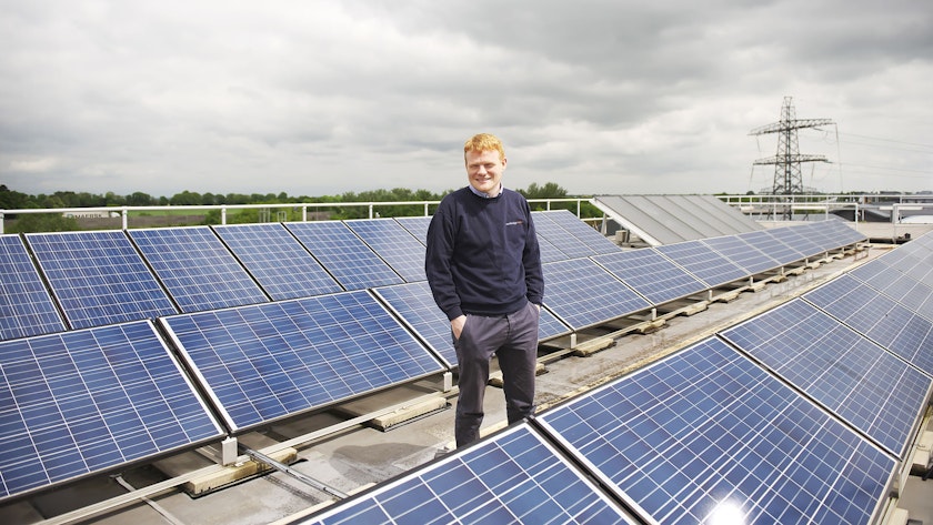 Owen Morgan standing next to PV Solar Panels
