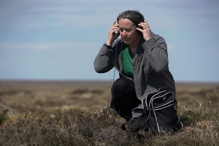 Women in a moor listening to headphones. Photo credit James Cook BBC News