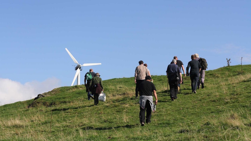 Walking up to the community wind turbine above CAT