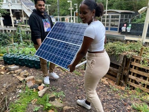 Carrying a PV Solar Panel through a garden