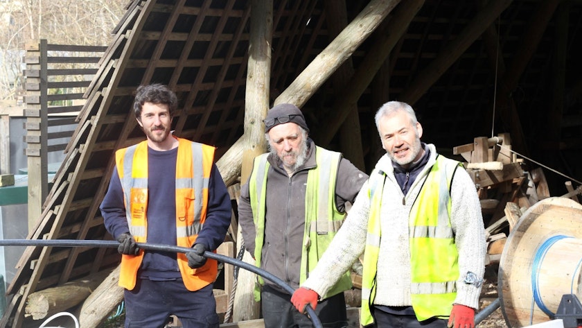 Engineers installing cable to connect with BDCR PV array at CAT