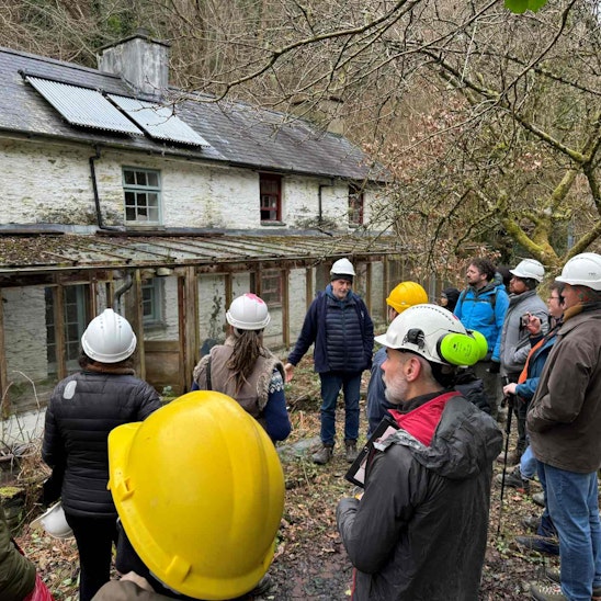 CAT’s postgraduate students learning from the ongoing planning and surveying work taking place ahead of renovating the currently unoccupied Quarry cottages on-site. CREDIT: Centre for Alternative Technology